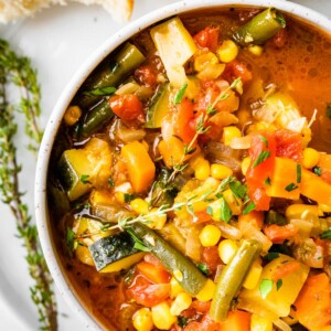 An overhead view of a bowl of vegetable soup.