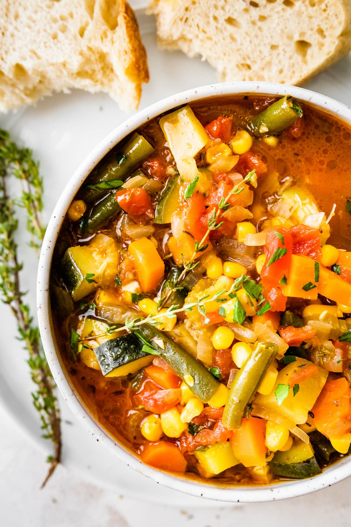 An overhead view of a bowl of vegetable soup.