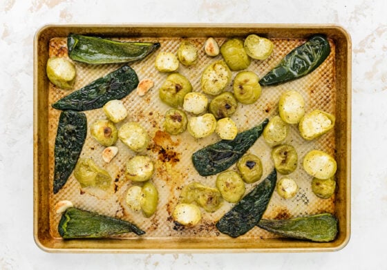 Tomatillos, poblano peppers and garlic broiled on a baking sheet.