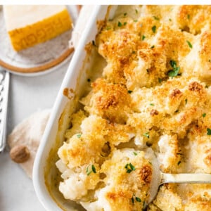 A spoonful of cauliflower gratin in a baking dish.