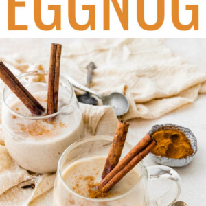 Two glasses of dairy free eggnog with cinnamon sticks.