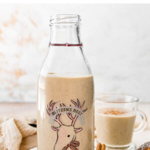 A jug and a glass of dairy free eggnog.