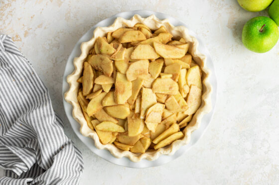 Apple slices in pie plate.