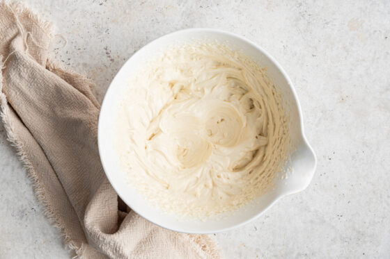 Cream cheese frosting mixed together in a bowl.