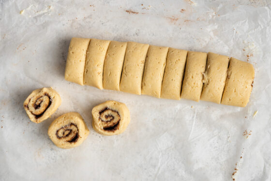 The log of dough is cut into 12 even slices.