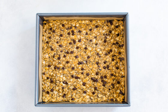 Mixture pressed into a square baking pan lined with parchment paper.