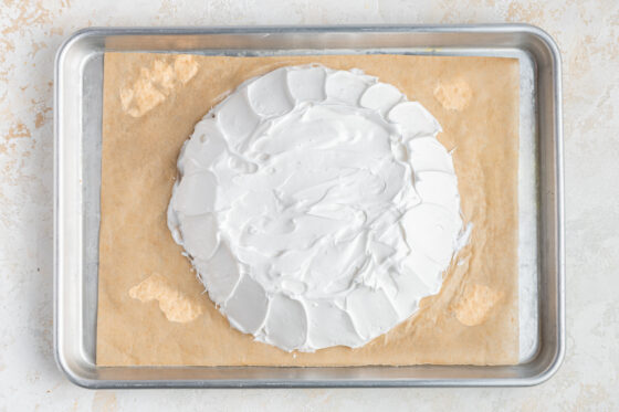 Egg white mixture shaped onto a sheet pan lined with parchment paper.