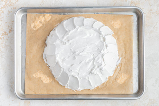 Egg white mixture shaped onto a sheet pan lined with parchment paper.