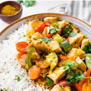 Chicken curry and vegetables served with rice.