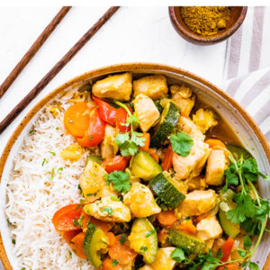 Chicken curry and vegetables served with rice.