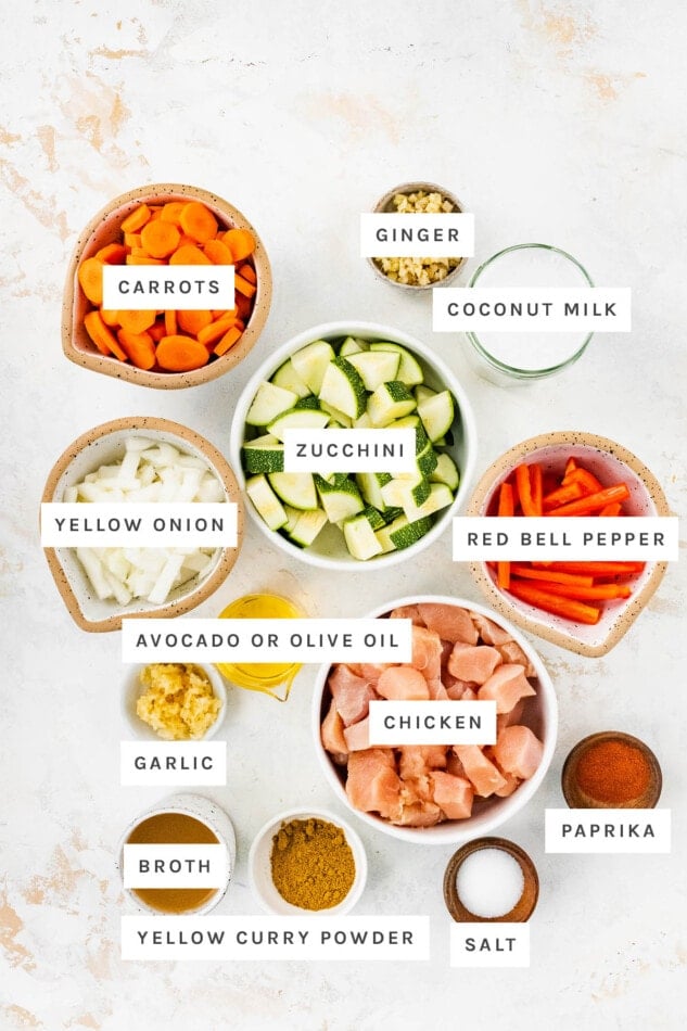 Ingredients measured out to make Chicken Curry: carrots, ginger, coconut milk, zucchini, yellow onion, red bell pepper, avocado or olive oil, garlic, chicken, broth, yellow curry powder, salt and paprika.