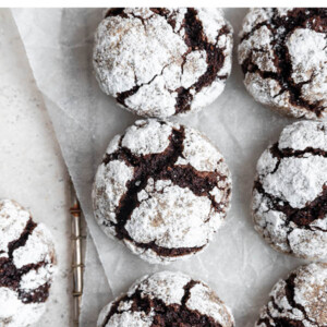 Chocolate crinkle cookies on a wire tray.