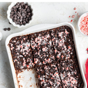 A baking dish containing chocolate peppermint baked oatmeal. A serving is missing from the bottom corner.