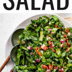 Collard green salad on a plate with serving spoons.