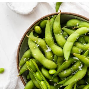 Bowl of salted edamame pods.