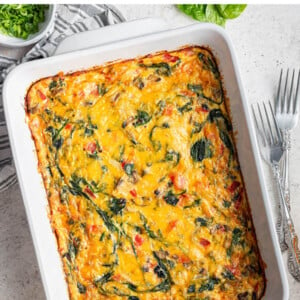 Cheesy, veggie-packed hash brown casserole in a pan.