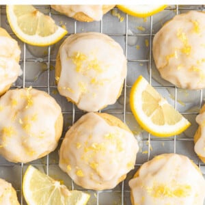 Cookies and lemon wedges on a wire cooling rack.