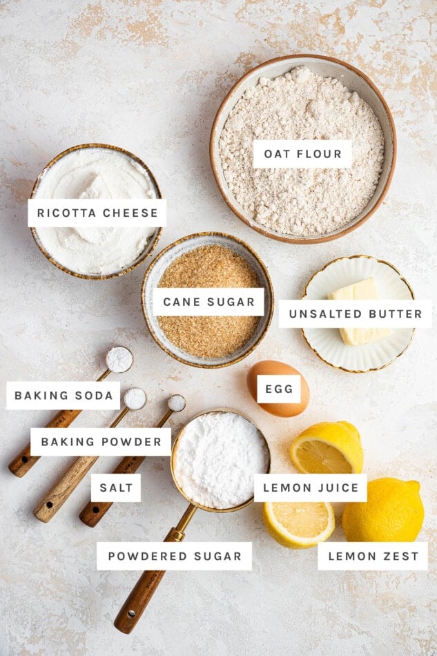 Ingredients measured out to make Lemon Ricotta Cookies: oat cookies, ricotta cheese, cane sugar, unsalted butter, egg, baking soda, baking powder, salt, powdered sugar, lemon juice and lemon zest.