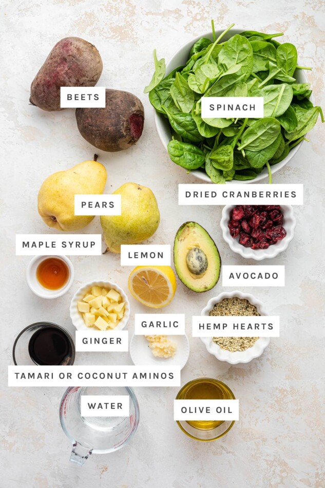 Ingredients measured out to make Pear and Beet Salad with a Ginger Hemp Dressing: beets, spinach, pears, dried cranberries, maple syrup, lemon, avocado, garlic, ginger, hemp hearts, tamari or coconut aminos, water and olive oil.