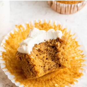 Sweet potato cupcake with a bite taken out of it.