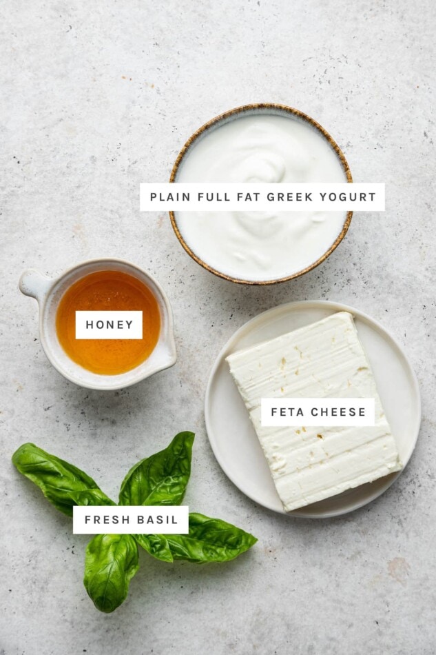 Ingredients measured out to make Whipped Feta Dip: plain full fat Greek yogurt, honey, feta cheese and fresh basil.