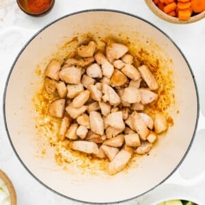 Chicken cooking in a pot.