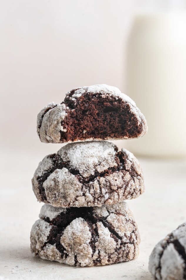 Three cookies stacked on top of each other. The top cookie is missing a bite.