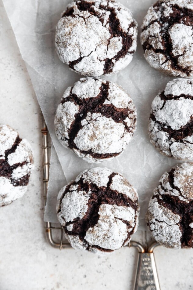 Chocolate crinkle cookies on a wire tray.
