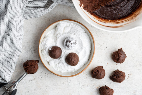 Cookie dough balls rolled in powdered sugar.