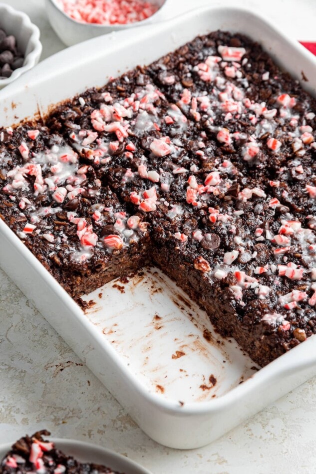 A square missing from a baking dish of chocolate peppermint baked oatmeal.