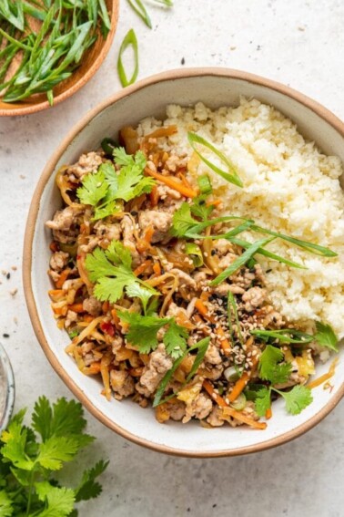 Egg roll in a bowl served with rice.