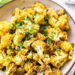 Curry roasted cauliflower in a bowl.
