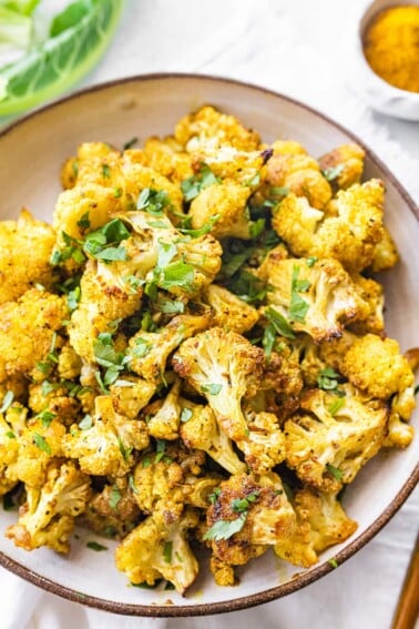 Curry roasted cauliflower in a bowl.