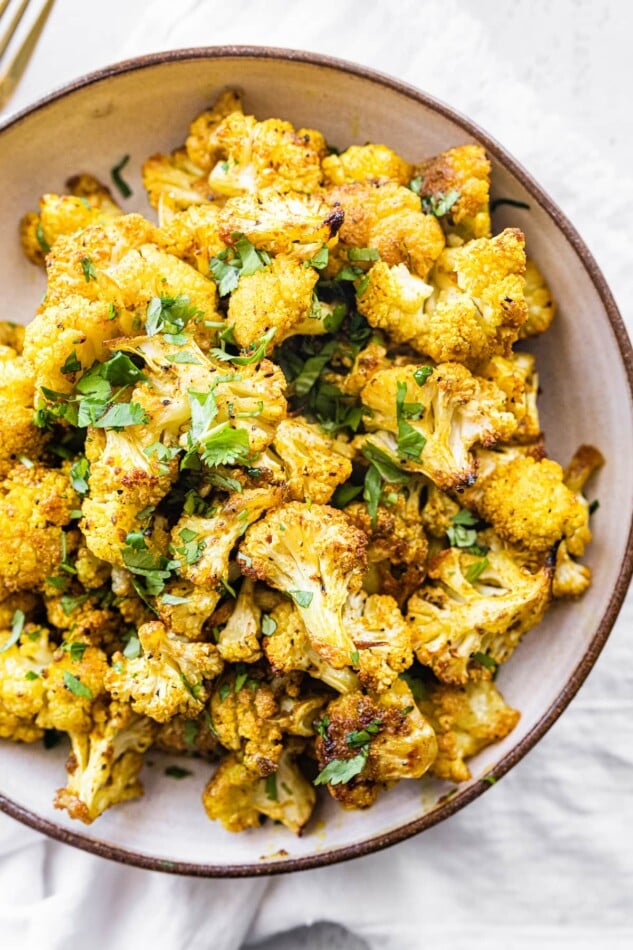 Curry roasted cauliflower in a bowl.