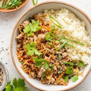 Egg roll in a bowl served with rice.