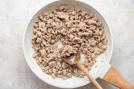 Ground turkey cooking in a sauté pan.