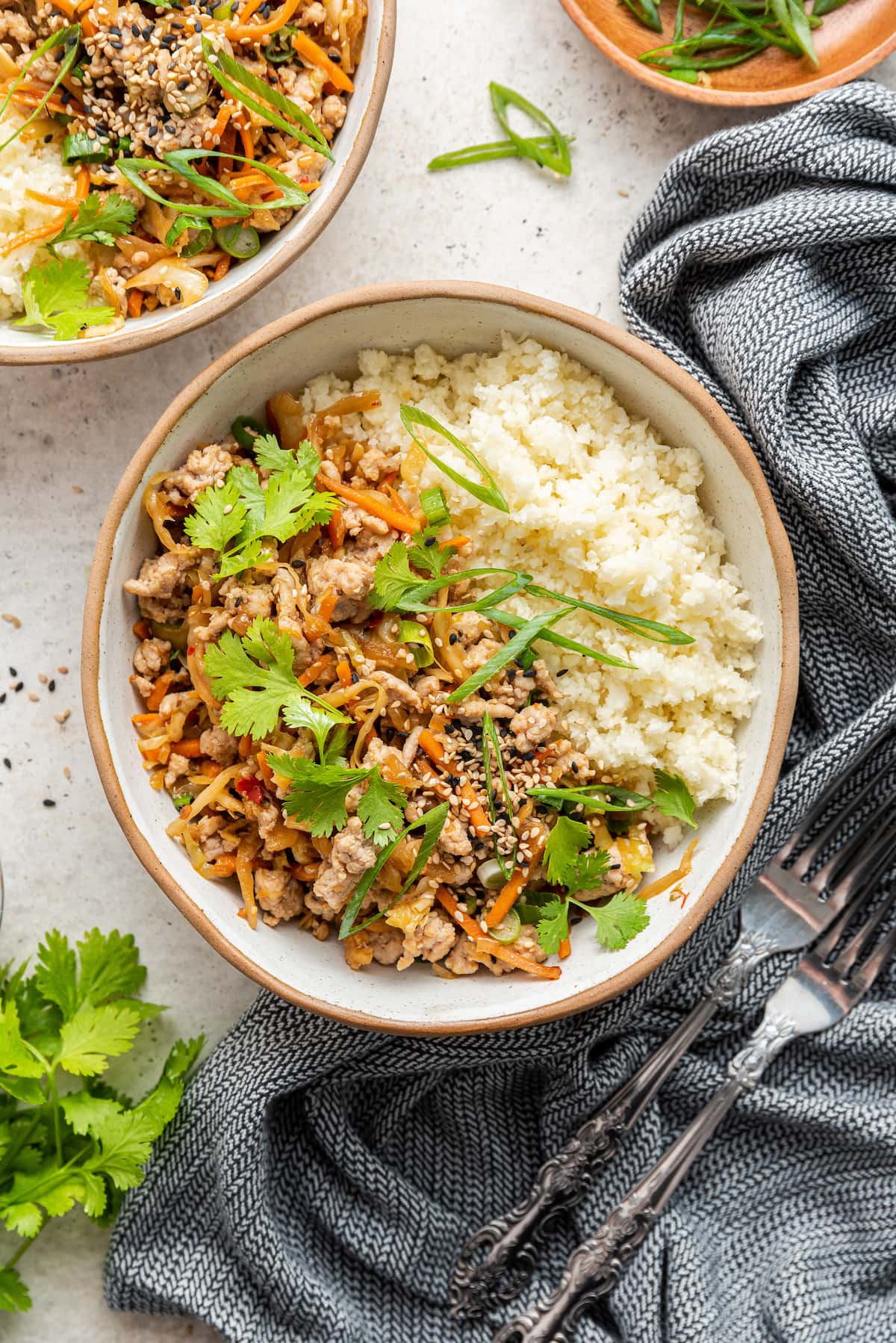 A bowl containing egg roll in a bowl served with rice.