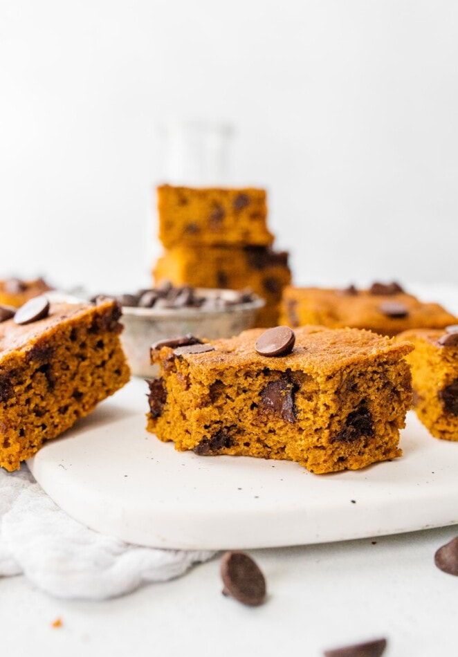 A pumpkin bar with a bite taken out of it.