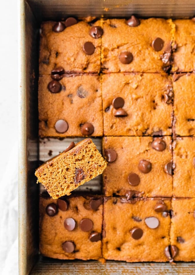 Squares of healthy pumpkin bars, one bar has been turned to it's side.