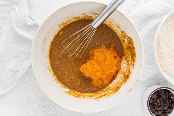 Wet ingredients mixed together with pumpkin puree added to the bowl.