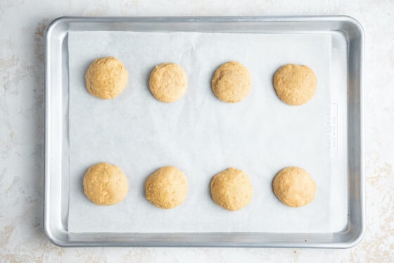 Lemon ricotta cookies on a baking sheet lined with parchment paper.