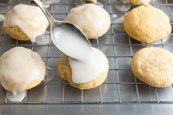 Glazing a cookie with a spoon.