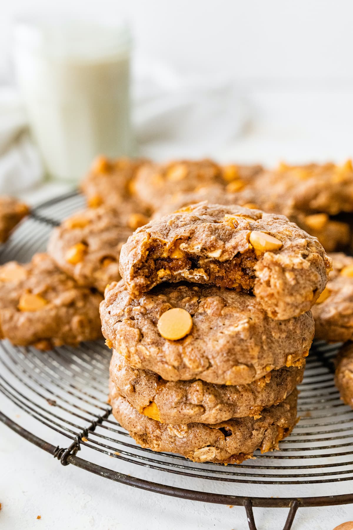 A stack of oatmeal scotchies, the top cookie has a bite taken out of it.