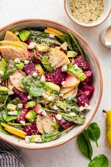 A salad bowl containing pear and beet salad.