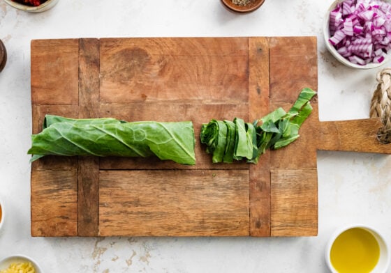 Collard greens rolled into a cigar shape for easy chopping.