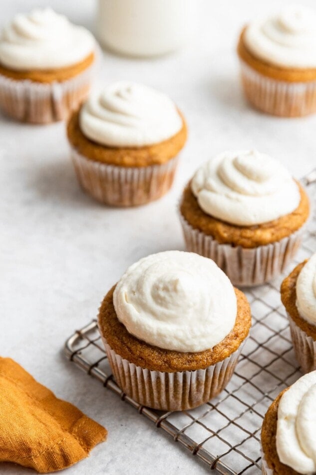 Frosted sweet potato cupcakes wrapped in paper liners.