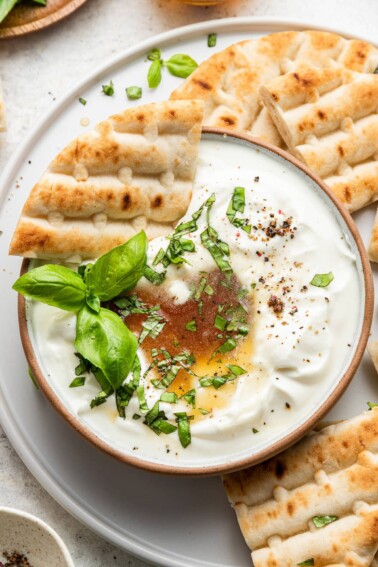 A triangle of pita dipped into dip.