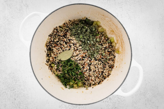 Wild rice and ingredients in a pot.