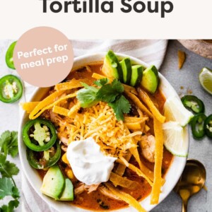 Bowl of chicken tortilla soup with toppings.