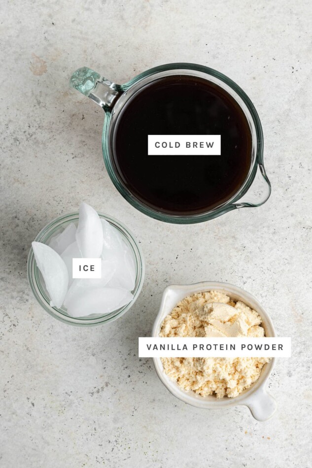 Ingredients measured out to make Protein Coffee: cold brew, ice and vanilla protein powder.